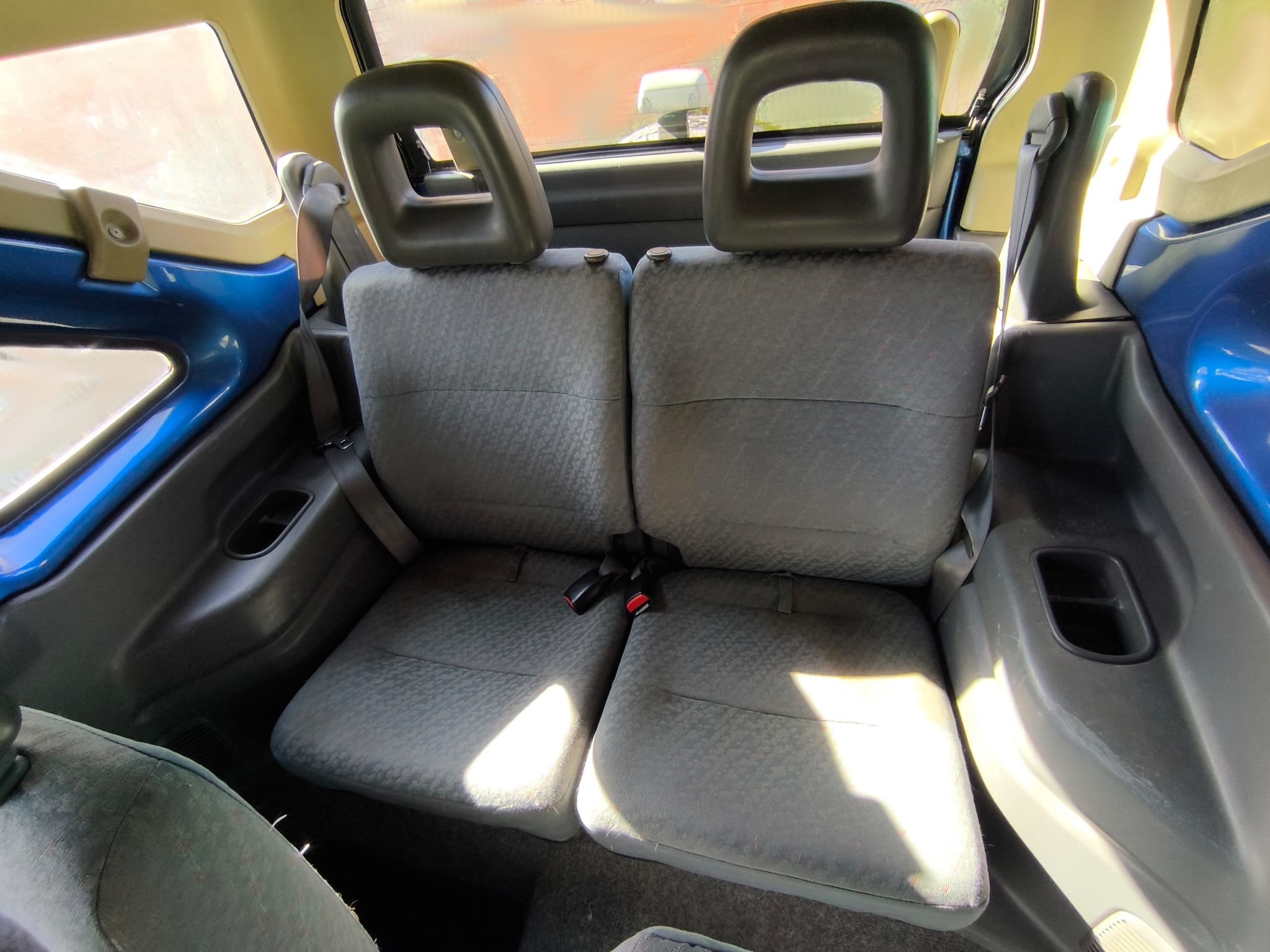Vista interior desde puerta abierta: asiento conductor, suelo y salpicadero